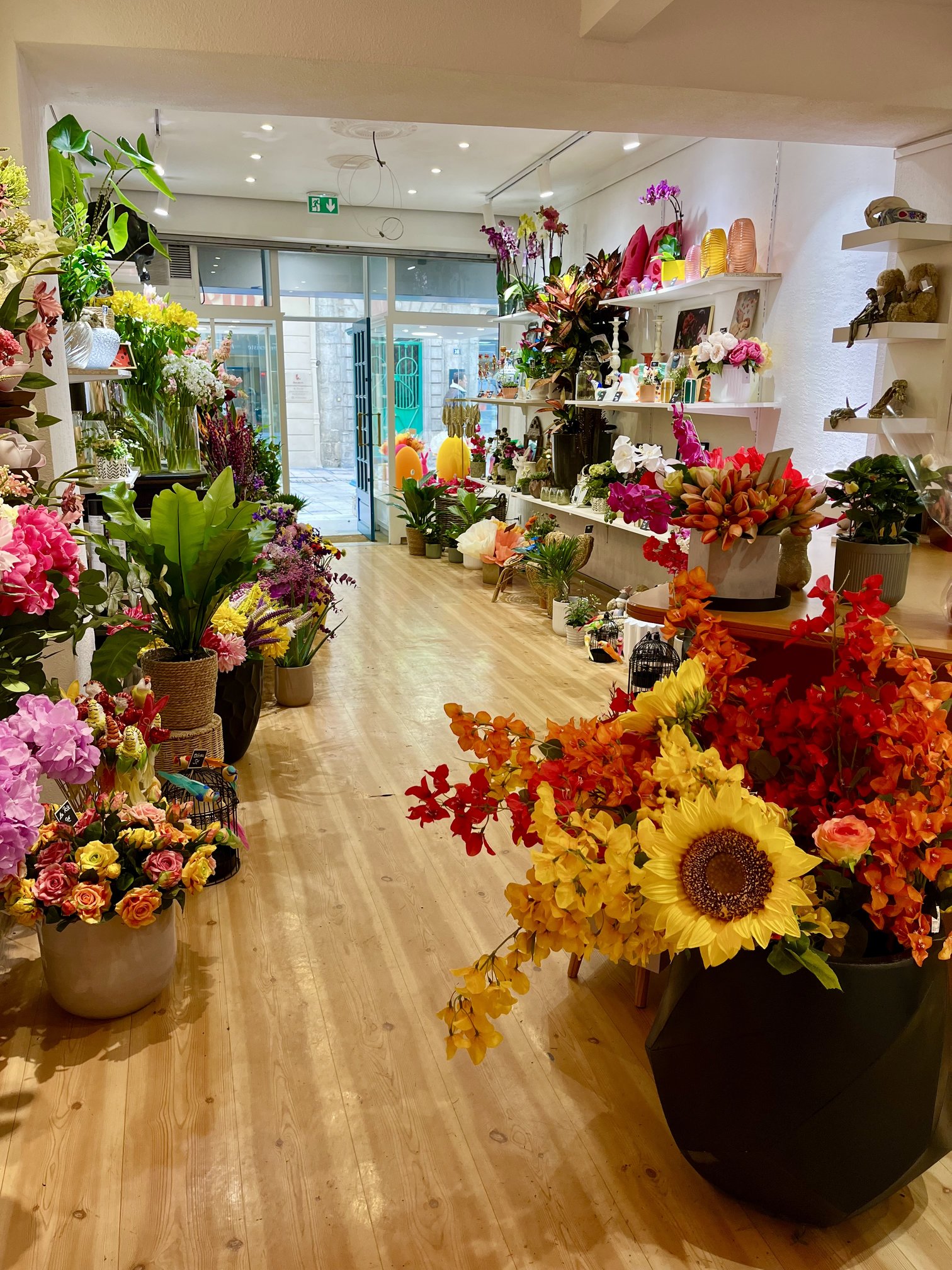 Entrée de la boutique Maluna avec compositions de tournesols et fleurs artificielles